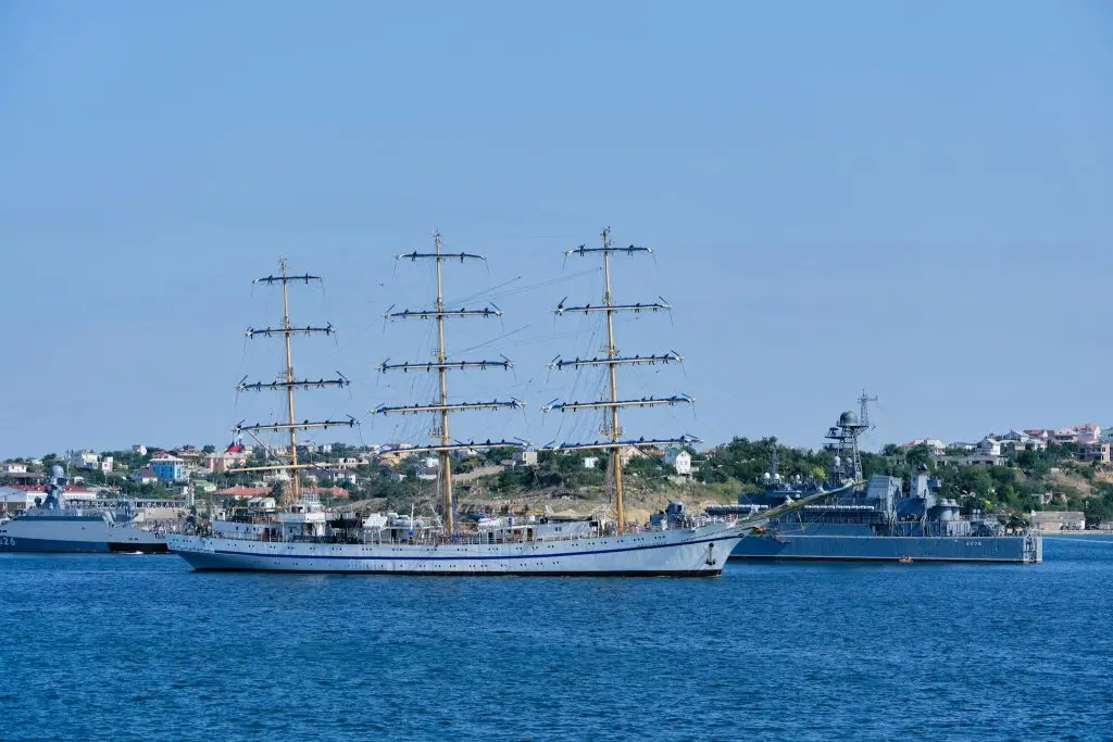A majestic tall ship anchored in Sevastopol harbor, showcasing nautical beauty under a clear blue sky.
